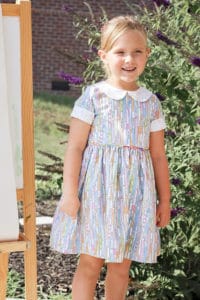 Simple Life Pattern Company | Wendy's Classic Collar Dress Downloadable PDF Sewing Pattern for Girls and Toddlers sizes 2-12. Wendy is available in GIRL, BABY and DOLL sizes.  This is a classic vintage-style dress you will absolutely fall in love with.  Designed for woven fabrics, this pattern features endless options.  Wendy features a simple bodice with optional peter-pan collar.  Trim the collar with piping or crochet lace for a special look.  This pattern offers a full coverage back that buttons (or snaps) up the back. Choose from sleeveless, short, 3/4, and long with or without optional cuffs.  The skirt is a full gathered skirt with a deep hem and optional inseam pockets.  As the perfect finishing touch there is an optional skinny belt with belt loops to keep it in place.  This dress is great for everyday play or dress it up with satin and sequins for a special occasion.