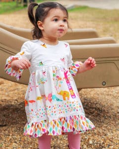 Baby Patricia's Boho High Low Top & Dress.. Downloadable PDF Sewing Pattern for Baby Sizes Newborn to 24 Months. Baby Patricia’s is packed full of options. Starting with Top or dress length. It also has a sleeveless version, short sleeves, bell sleeves, and long sleeves. You can choose between the moderate high low hem or the dramatic high low hem. Baby Patricia can be made in knit or woven’s and is very flattering in lightweight flowy types of fabrics such as voile or rayon. The back features a slight scoop back and has NO closures – just slides on over the child’s head. Plenty of playing room without being boxy or too baggy. You will love how many looks you can achieve with just this pattern! And how quickly you can sew these up!