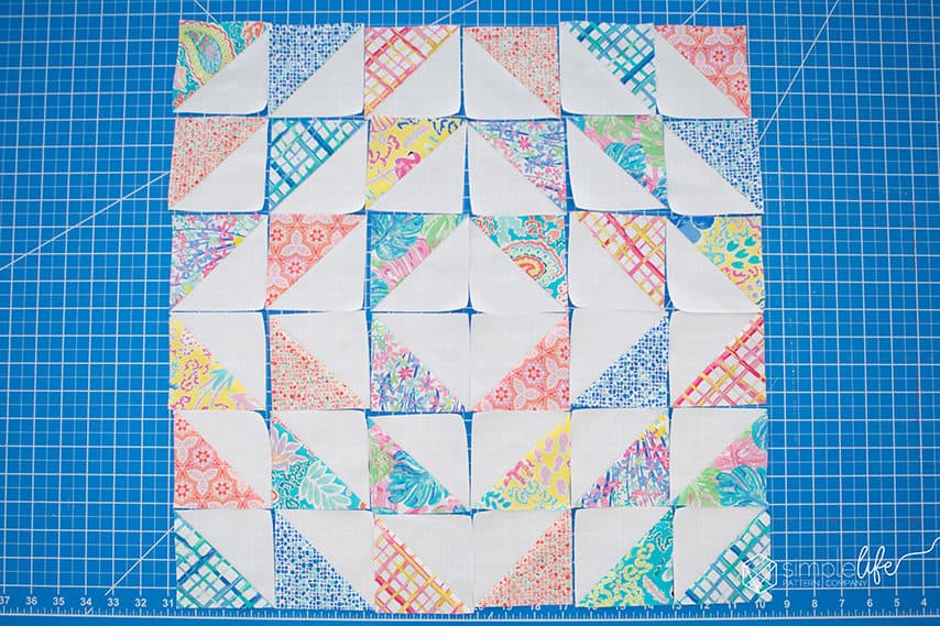 Half Square Triangle 18" pillow cover OR quilt block by Simple Life Pattern Company HST fast easy beginner tutorial sewing pattern for the envelope back quilted pillow form cover case. Art Gallery Fabrics West Palm Fabrics by Katie Skoog. Cricut maker rotary blade cutter cutting machine embellished quilt pillow 18" block square up with the bloc loc ruler couch floor or throw decorative pillow using the cricut no vinyl fast sewing project to decorate your home