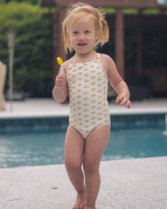 Simple life Pattern Company | Baby Marina's Criss Cross Tankini and One Piece. Downloadable PDF Sewing pattern for Baby sizes Newborn to 24 months. Baby Marina features the on-trend criss-cross strap in the back.  It can be sewn as a one piece or a tankini.  Both versions can feature the optional top ruffle or it can be made as a simple swimsuit without the ruffle.  The tankini also has an optional skirt ruffle for the ultimate girly swimsuit.  Fully lined or partial lining.  A shorten/lengthen line is included for the perfect fit and coverage you may want.  If you prefer a one piece for more sun coverage, an optional snap crotch panel is included for easy diaper changes.