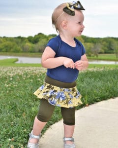 Simple Life Pattern Company | Baby Roxie's Skirted Leggings. Downloadable PDF Sewing Pattern for Baby Sizes Newborn to 24 Moths. Baby Roxie's Skirt Leggings are perfect for pairing with all our tops, especially the Lydia. Baby Roxie features 3 patterns in 1 pattern. Simple basic leggings, skirted leggings or a simple skirt.  There are three legging lengths- pants, capri or shorts. Baby Roxie features an elastic waistband and optional faux drawstring. This is sure to become a staple pattern for any season from back to school to hot summer days and everyday in between. New to knit? Don’t worry!! The pattern has helpful tips and tricks to make sewing with knits a breeze! You learn about what type of knit to buy, the preferred needles for sewing knits, and which stitch to use on your sewing machine. The best part about knits is that they don’t fray, so it is not necessary to hem them, although that is an option explained in the patterns. You’ll find that sewing knits is much faster than sewing wovens! These patterns will help you jump in and discover a love for knits (if you haven’t already)!