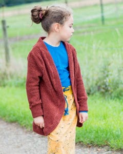 Simple Life Pattern Company | Tiegan's Cozy Cardigan & Duster. Downloadable PDF Sewing Patterns for Toddler and Girl Sizes 2T-12. Tiegan is a relaxed/ loose fitting cardigan and duster drafted for your favorite sweater knits, double brushed poly, or favorite cozy knit.  Tiegan has 3 lengths to choose from, crop, cardigan or duster.  The crop and cardigan have 2 different hem lines you can choose from, curved or straight, while the duster offers only the straight hem with a side vent.  You can choose a simple neckband or ruffled neckband for an added detail design.  With 4 sleeve options this pattern can transition easily through all of the seasons.  Choose from sleeveless, a simple long sleeve, cuffed long sleeve or a ruffled cuff long sleeve.  