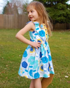 Simple Life Pattern Company| Tinsley's Scalloped Top, Romper & Dress. Downloadable PDF Sewing Pattern for Toddler and Girl Sizes 2T to 12. The perfect pattern for spring and summer sewing, Tinsley features super cute shoulder tie that lets just a little bit of the lining show through for the perfect contrast.  Choose from a swing top, dress or romper.  Choose scallop or simple hemline.  This pattern also features a front button placket and optional slash pockets.  Pair the swing top with Maggie’s Suspender Shorts or Seaside Shorts for the perfect outfit.