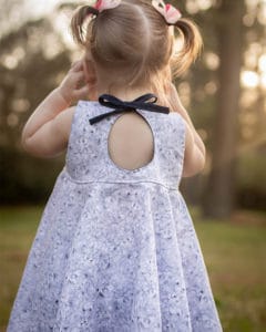 Simple Life Pattern Co. | Baby Ivy's Angel Sleeve Top & Dress. Downloadable PDF Sewing Pattern for Babies Size Newborn to 24 Months. Ivy is a sweet vintage inspired beauty! Ivy's Angel Sleeve Top & Dress features babydoll style bodice that can be sewn simple or with the optional pin tuck placket for such a sweet look.  The angel sleeves on Ivy give this pattern such a feminine and sweet look.  It can also be made sleeveless if you prefer.  There are 3 skirt options for Ivy: a top length, vintage length, and a knee-length! The skirt has options for a simple gathered skirt or circle skirt that is sure to have your girl twirling the day away! The look is finished with a beautiful circle keyhole in the back with a tie closure.  