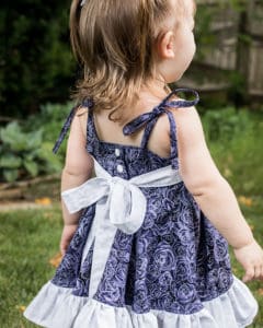 Baby Opal's Wrap Skirt Top & Dress. Downloadable PDF Sewing Pattern for Baby Sizes Newborn to 24 Months. Baby Opal's Wrap Skirt Top & Dress is the sweetest sundress you'll own??  With two adorable necklines options, a slight sweetheart or adorable square neckline, Baby Opal is sure to be a favorite of yours and the little lady you are sewing for.  Baby Opal offers two skirt lengths: tunic and dress length.  The skirt has so many beautiful options, this pattern has something for everyone.  With a circle skirt or gathered skirt option you can create a simple skirt, a ruffled skirt, a simple wrap skirt or a fully ruffled wrap skirt.  Heading to a fancy affair?  Dress Opal up by adding the optional front sash and ties.  Not feeling fancy today?  Leave them off completely or add the sweet front bow for a more causal look.  The back bodice closes with buttons or snaps.  Baby Opal has delicate ties straps to finish this summer staple off with a sweet feminine look.