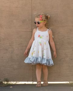 Opal's Wrap Skirt Top & Dress. Downloadable PDF Sewing Pattern for Toddler & Girl Sizes 2T-12. Opal's Wrap Skirt Top & Dress is a sweet sundress with an option of a slight sweetheart or adorable square neckline.  It will be a favorite of yours and the little lady you are sewing for.  Opal offers two skirt lengths: tunic and dress length.  The skirt has so many beautiful options, this pattern has something for everyone.  With a circle skirt or gathered skirt option you can create a simple skirt, a ruffled skirt, a simple wrap skirt or a fully ruffled wrap skirt.  The back bodice closes with buttons or snaps.  Opal has delicate ties straps to finish this summer staple off with a sweet feminine look.