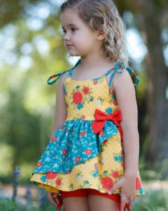 Opal's Wrap Skirt Top & Dress. Downloadable PDF Sewing Pattern for Toddler & Girl Sizes 2T-12. Opal's Wrap Skirt Top & Dress is a sweet sundress with an option of a slight sweetheart or adorable square neckline.  It will be a favorite of yours and the little lady you are sewing for.  Opal offers two skirt lengths: tunic and dress length.  The skirt has so many beautiful options, this pattern has something for everyone.  With a circle skirt or gathered skirt option you can create a simple skirt, a ruffled skirt, a simple wrap skirt or a fully ruffled wrap skirt.  The back bodice closes with buttons or snaps.  Opal has delicate ties straps to finish this summer staple off with a sweet feminine look.