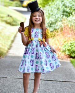Simple Life Pattern Company | Geneva's Vintage Bow Dress. Downloadable PDF Sewing Pattern for Toddler and Girl Sizes 2T-12. Designed for Woven Geneva's Vintage Bow Dress is a stylish dress with the most beautiful vintage feel.  Whether you are looking for an everyday dress or something more fancy for a special occasion this pattern will be a staple in your stash.  Featuring several stunning sleeve lengths: sleeveless, single flutter sleeves double flutter sleeves, an open short sleeve or long sleeve with ties...the styling options are endless! The bodice offers two gorgeous necklines, the traditional scoop neck or a more modern square neck.  You can choose a simple bodice, bodice with a simple center panel or bodice with a pin tuck center panel. Geneva includes several skirt options: a simple gathered vintage skirt, a gathered vintage skirt with center panel, a simple gathered dress skirt and a gathered dress skirt with center panel.  Vintage length is designed to fall 2” above the knee while dress length will fall at the knee. The skirt is finished off with a classic deep 2” hem, giving you the most stunning vintage look. The beautiful features don’t stop there.  To finish off this stunning look you have the option to add to beautiful bows to the sides of the bodice.