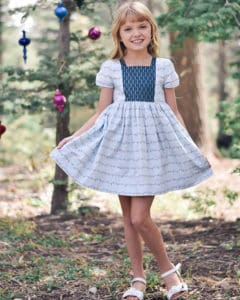 Simple Life Pattern Company | Geneva's Vintage Bow Dress. Downloadable PDF Sewing Pattern for Toddler and Girl Sizes 2T-12. Designed for Woven Geneva's Vintage Bow Dress is a stylish dress with the most beautiful vintage feel.  Whether you are looking for an everyday dress or something more fancy for a special occasion this pattern will be a staple in your stash.  Featuring several stunning sleeve lengths: sleeveless, single flutter sleeves double flutter sleeves, an open short sleeve or long sleeve with ties...the styling options are endless! The bodice offers two gorgeous necklines, the traditional scoop neck or a more modern square neck.  You can choose a simple bodice, bodice with a simple center panel or bodice with a pin tuck center panel. Geneva includes several skirt options: a simple gathered vintage skirt, a gathered vintage skirt with center panel, a simple gathered dress skirt and a gathered dress skirt with center panel.  Vintage length is designed to fall 2” above the knee while dress length will fall at the knee. The skirt is finished off with a classic deep 2” hem, giving you the most stunning vintage look. The beautiful features don’t stop there.  To finish off this stunning look you have the option to add to beautiful bows to the sides of the bodice.