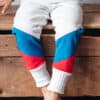 Simple Life Pattern Company Andes Color Blocked Joggers. Downloadable pdf sewing pattern with projector file. Designed for knit fabric. Kids and youth sizes 2t-16 boys, girls and teens sewing tutorial. Color blocking at the bottom of legs. Drawstring pants with pockets. Cozy comfortable play clothes for beginner sewing.