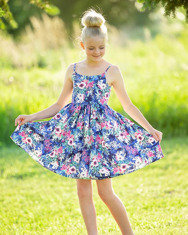 Simple Life Pattern Company PDF downloadable interactive sewing patterns for girls, toddlers and kids. Lakeside bow back tie dress with elastic back for grow with me sizing. Spaghetti strap tutorial with contoured gathered skirt. Large scale print and embroidery and embellishment friendly. SLPco scoop neck scoop back dress for casual play or dress it up for holidays. Summer spring fall projector file pattern. A0 file and print at home.